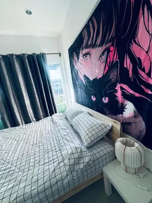 a bedroom with a large painting on the wall at HulaFling Homestay in Ban Bo Han