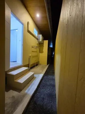 a hallway of a building with stairs and a window at Cozy Stay Koh Yao Yai in Ko Yao Yai