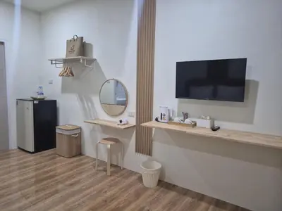 a room with a counter with a tv and a mirror at Cozy Stay Koh Yao Yai in Ko Yao Yai