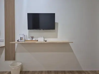 a room with a shelf with a tv on a wall at Cozy Stay Koh Yao Yai in Ko Yao Yai
