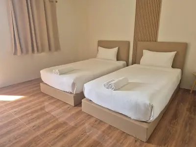 two beds sitting next to each other in a room at Cozy Stay Koh Yao Yai in Ko Yao Yai