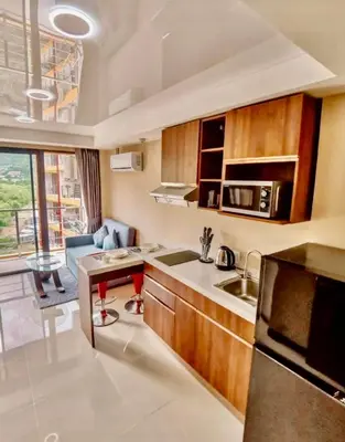 a small kitchen with a sink and a microwave at Bright Sun Apartment with Pools in Rawai Beach