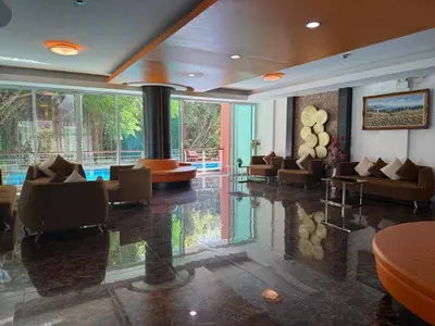 a lobby with couches and chairs in a building at Phuket Rawai beachfront by Tris in Nai Harn Beach