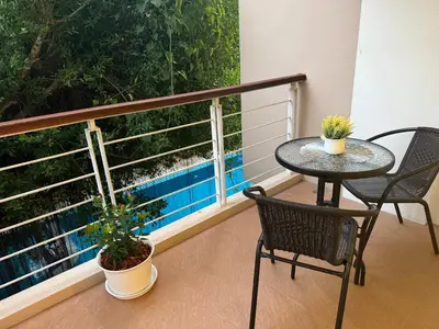 a balcony with a table and two chairs and a window at Phuket Rawai beachfront by Tris in Nai Harn Beach