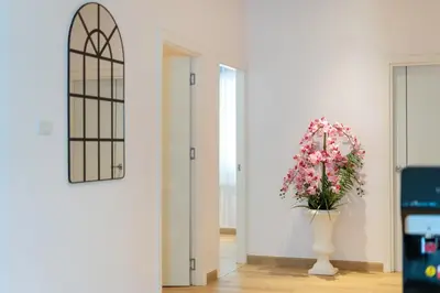 a hallway with a vase with flowers in it at Espuma Patong pool villa in Patong Beach