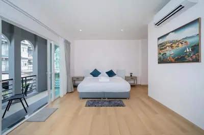 a bedroom with a bed and a painting on the wall at Espuma Patong pool villa in Patong Beach