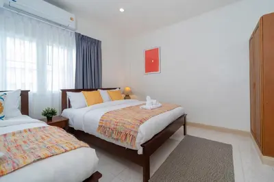 a bedroom with two beds and a window at Suite dream villa Bangla Patong sleep 8 in Patong Beach
