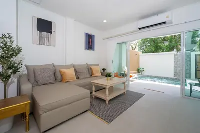 a living room with a couch and a table at Suite dream villa Bangla Patong sleep 8 in Patong Beach