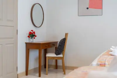 a desk with a chair and a mirror on a wall at Suite dream villa Bangla Patong sleep 8 in Patong Beach