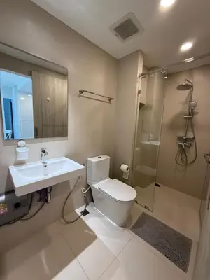 a bathroom with a toilet and a sink and a shower at Sky Park Family Comfort in Laguna Phuket