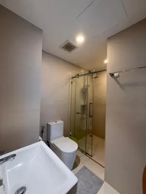 a bathroom with a shower and a toilet and a sink at Sky Park Family Comfort in Laguna Phuket