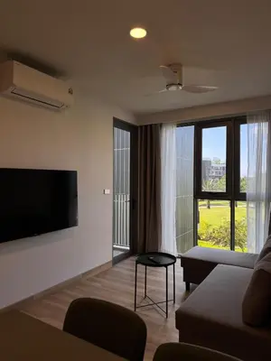 a living room with a couch and a flat screen tv at SkyPark Laguna, 1 Bedroom Apartment in Phuket