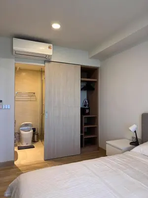 a bedroom with a white bed and a bathroom at SkyPark Laguna, 1 Bedroom Apartment in Phuket