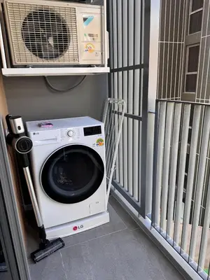 a washing machine in a room with a fan at SkyPark Laguna, 1 Bedroom Apartment in Phuket