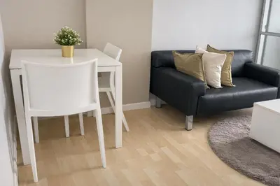 a living room with a table and a couch at studio room dami in Kathu