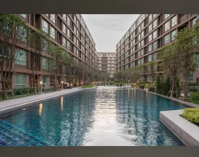 a large swimming pool in the middle of a building at studio room dami in Kathu