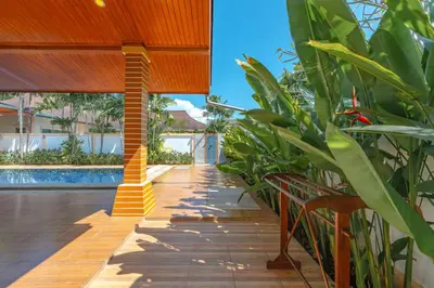 a patio with a row of plants next to a pool at Orchid Pool Villa 8 Rawai in Rawai Beach