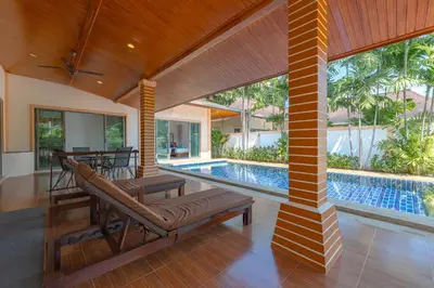 an open living room with a swimming pool and a house at Orchid Pool Villa 8 Rawai in Rawai Beach