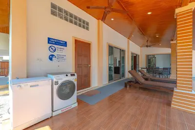 a washer and dryer in a house with a porch at Orchid Pool Villa 8 Rawai in Rawai Beach