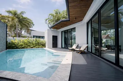 a swimming pool in the backyard of a house at Private Pool Villa Baan Bua in Phuket Town