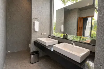 a bathroom with two sinks and a large mirror at Private Pool Villa Baan Bua in Phuket Town