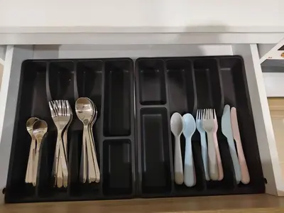a black plastic utensils holder with forks and spoons at The Blue Oasis Cozy Phuket Getaway in Ban Ket Ho