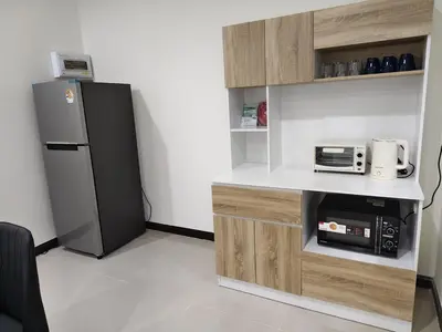 a small kitchen with a refrigerator and a microwave at The Blue Oasis Cozy Phuket Getaway in Ban Ket Ho