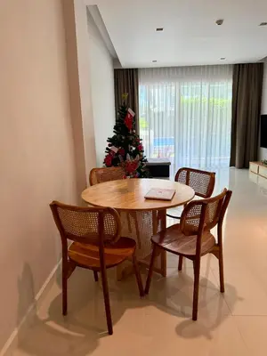 a dining room with a table and chairs and a christmas tree at Luxury 112 m 2BR, Direct Pool Access, 1st Line, Klong Muang Beach in Ban Ko Kwang