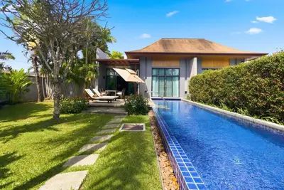 a swimming pool in the backyard of a house at Onyx Villa by Beringela in Rawai Beach