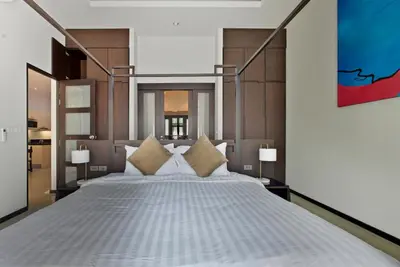 a bedroom with a large white bed with pillows at Onyx Villa by Beringela in Rawai Beach
