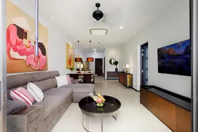 a living room with a couch and a table at Onyx Villa by Beringela in Rawai Beach