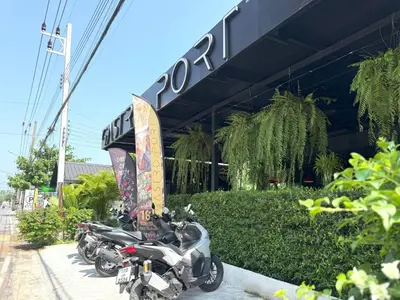 a row of motorcycles parked in front of a building at Apple House seaside home and pool in Ban Lum Fuang