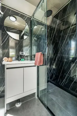 a bathroom with a glass shower and a sink at Apple House seaside home and pool in Ban Lum Fuang