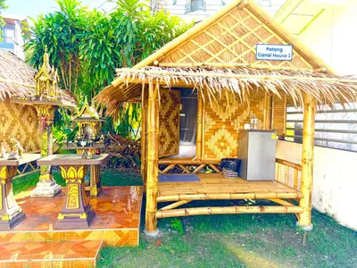 a small hut with a table and a refrigerator at Patong Canal House 3 in Patong Beach