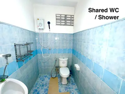 a blue tiled bathroom with a toilet and a sink at Patong Canal House 3 in Patong Beach