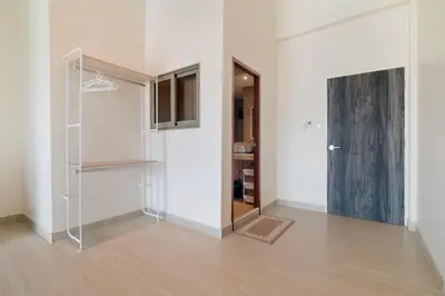 an empty room with a glass door and a hallway at Patong Boutique in Patong Beach
