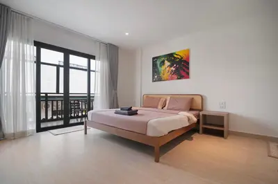 a bedroom with a bed and a large window at Patong Boutique in Patong Beach