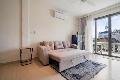 a living room with a couch and a large window at Patong Boutique in Patong Beach