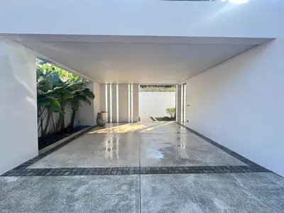 an empty hallway of a house with a white wall at Anchan Grand Residence Bangtao in Ban Pak Lak