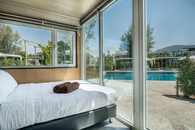 a bedroom with a bed with a towel on it at Apple House Pool, Breakfast & Beaches in Ban Lum Fuang