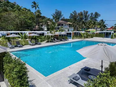 an image of a swimming pool at a resort with umbrellas at Apple House Bangtao Beach pool, terrace, breakfast in Ban Lum Fuang