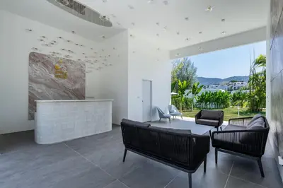 a living room with a couch and chairs and a fireplace at Apple House Phuket Near Beach with Pool & Terrace in Ban Lum Fuang