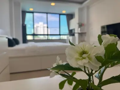 a vase with a white flower in a living room at Lahan 4 in Patong Beach