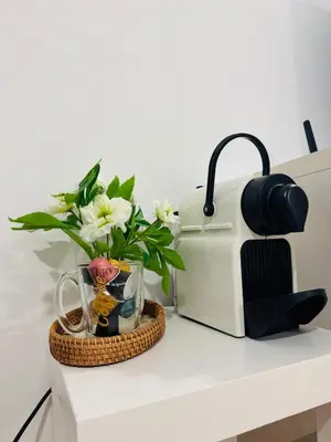 a kitchen counter with a toaster and a vase with flowers at Lahan 4 in Patong Beach