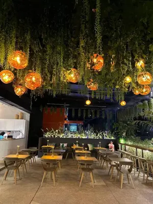 a restaurant with tables and chairs and lights at Apple House Bangtao with Pool & Terrace, beach in Ban Lum Fuang