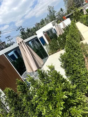 a house with a garden with a patio at Apple House Bangtao with Pool & Terrace, beach in Ban Lum Fuang