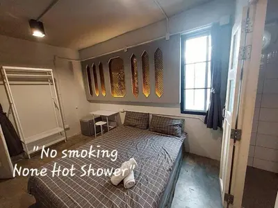 a bedroom with a bed with no smokingono hot shower at Fan Room Near Bangkok hospital Across Night market in Ban Ket Ho