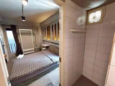 a small bedroom with a bed and a shower at Fan Room Near Bangkok hospital Across Night market in Ban Ket Ho