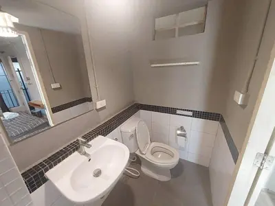 a bathroom with a sink and a toilet and a mirror at Fan Room Near Bangkok hospital Across Night market in Ban Ket Ho