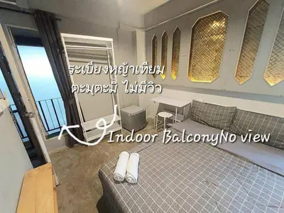 a room with a couch and a table and windows at Fan Room Near Bangkok hospital Across Night market in Ban Ket Ho